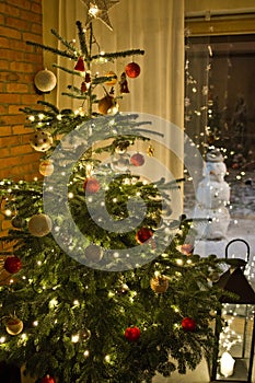 Christmas tree in modern home with snowman outside