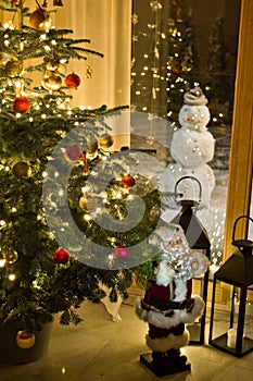 Christmas tree in modern home with snowman outside