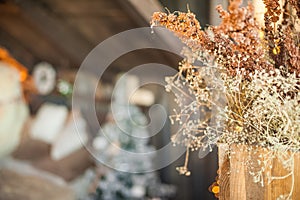 Christmas tree near the bed. Dried grass in a vase, defocus, bokeh. Scandinavian style bedroom interior under Christmas. Rustic Te