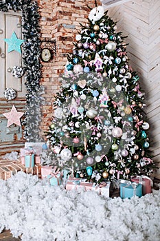 Christmas tree and New Year decorated interior room with with pink,tiffany presents under decorated tree.