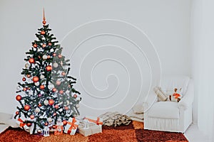 Christmas tree on new year`s Eve in a white room with Christmas gifts