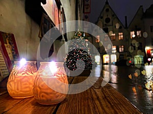 Christmas tree onstreet cafe wooden table lantern candle light ,holiday in the city Tallinn old town hall square, best mark