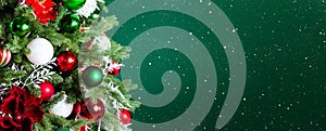 Christmas tree with ornaments, balls and lights on dark green background