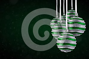 Christmas tree ornaments hanging. Balls made of glass or plastic hanging over abstract background