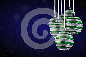 Christmas tree ornaments hanging. Balls made of glass or plastic hanging over abstract background