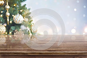 Christmas tree out of focus background over brown wooden table