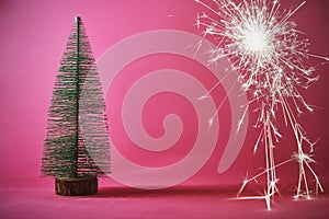 christmas tree on pink background with sparkle