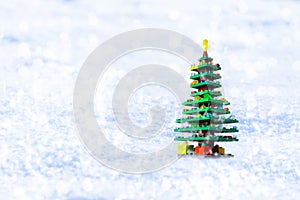 Christmas tree from plastick blockes on white snow