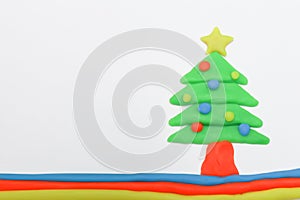 Christmas tree play dough close up image on white background.