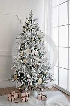 Christmas tree with presents underneath in living room