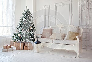 Christmas tree with presents underneath in living room photo