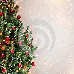 Christmas tree with red Christmas decorations on holiday background with snow, blurred, sparking