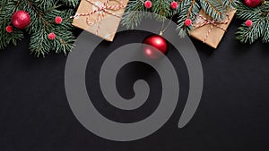 Christmas tree with red decorations and gifts on black background. Flat lay, top view, overhead. Christmas banner mockup