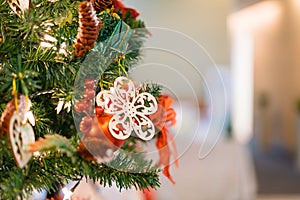 Christmas tree with red, green and golden snow flake ornament with blurry background and copy space