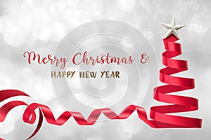 Christmas tree ribbon red bow band isolated with clipping path with star on silver snow background Merry Xmas and Happy new year