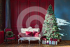 Christmas tree in royal interior. New Year`s Living Room with antique stylish white sofa with luxurious golden accessories. Gifts