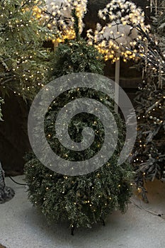 Christmas tree for sale with artificial decoration of non-real organic and realistic pine