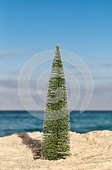 Christmas Tree on sandy tropical beach, holiday concept