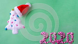 Christmas tree Santa hat. Santa`s Claus at home at night making magic