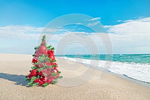 Christmas tree on the sea beach. Christmas vacation concept.