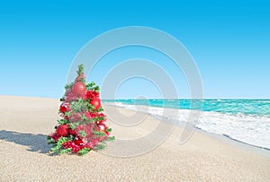 Christmas tree at sea beach. New Years vacation concept.