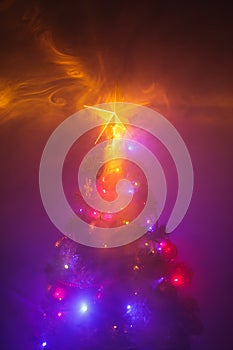 Christmas tree with shining star and dense smoke