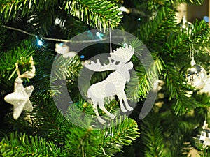 A Christmas tree with silver ornaments is a festive sight. Selective focus.