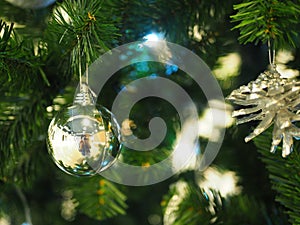 A Christmas tree with silver ornaments is a festive sight. Selective focus.