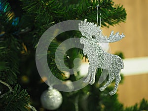 A Christmas tree with silver ornaments is a festive sight. Selective focus.