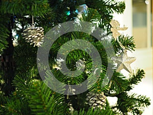 A Christmas tree with silver ornaments is a festive sight. Selective focus.