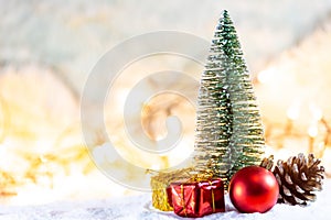 Christmas tree on snow with gift and light bokeh backgrounds ,Snowy Christmas or New Year festive background