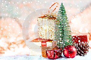 Christmas tree on snow with gift and light bokeh backgrounds ,Snowy Christmas or New Year festive background