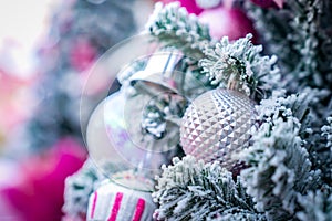 Christmas Tree with snowflake is decored with ball, presents and gift in pink theme for Christmas and new year event