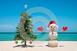 Christmas Tree and Snowman on the beach. Sandy Snowman. Merry Christmas. Happy New Year. Winter Holidays.