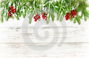 Christmas tree sprigs with red berries. Winter holidays decoration