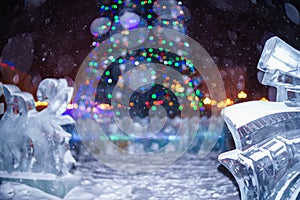 Christmas tree surrounded by Ice sculpture during snowy night photo