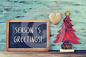 Christmas tree and text seasons greetings in a chalkboard