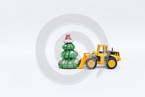 Christmas tree toy with front loader truck on white background