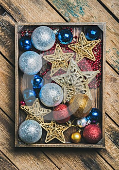 Christmas tree toy stars, balls and garland in wooden box