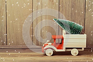 Christmas tree on toy truck car. Christmas holiday concept