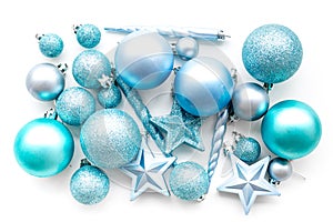 Christmas tree toys background. Blue balls and stars on white background top view