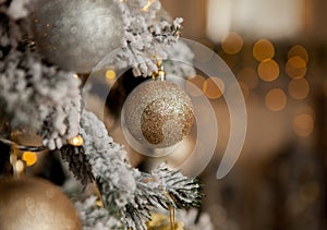 Christmas tree with toys and decorative snow for a happy new year on background of bokee