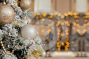 Christmas tree with toys and decorative snow for a happy new year on background of bokee