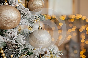 Christmas tree with toys and decorative snow for a happy new year on background of bokee