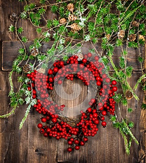 Christmas tree twigs and red berries wreath. Advent decoration