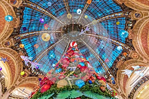 The Christmas tree under the dome of the Galeries Lafayette. The Galeries Lafayette has been selling luxury goods since 1895