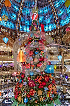 The Christmas tree under the dome of the Galeries Lafayette. The Galeries Lafayette has been selling luxury goods since 1895
