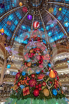 The Christmas tree under the dome of the Galeries Lafayette. The Galeries Lafayette has been selling luxury goods since 1895