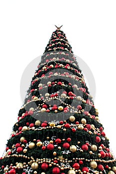 Christmas tree on a white background. New Year's festive tree. Christmas festive balls and decorations on the tree