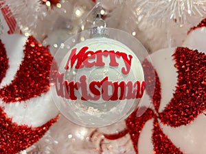Christmas tree with white ball with the text merry christmas